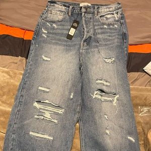 Size 13 NOT size 14 high waist distressed medium wash boot cut.Button up closure